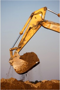 an excavator moving dirt waste