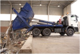 skip bin truck throwing away mixed waste