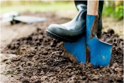 a man using shovel to dig soil