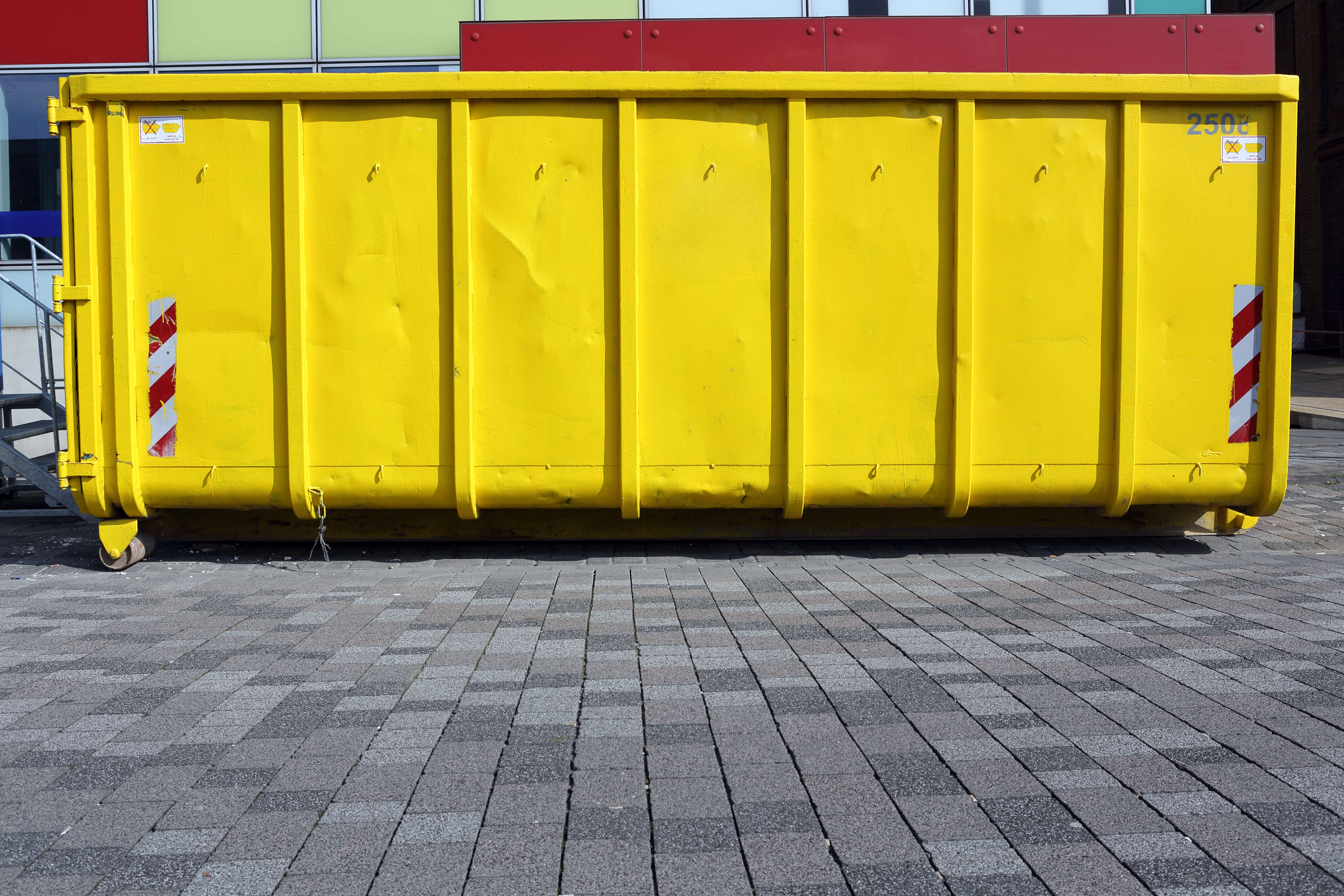 This is a picture of a yellow hook lift skip bin