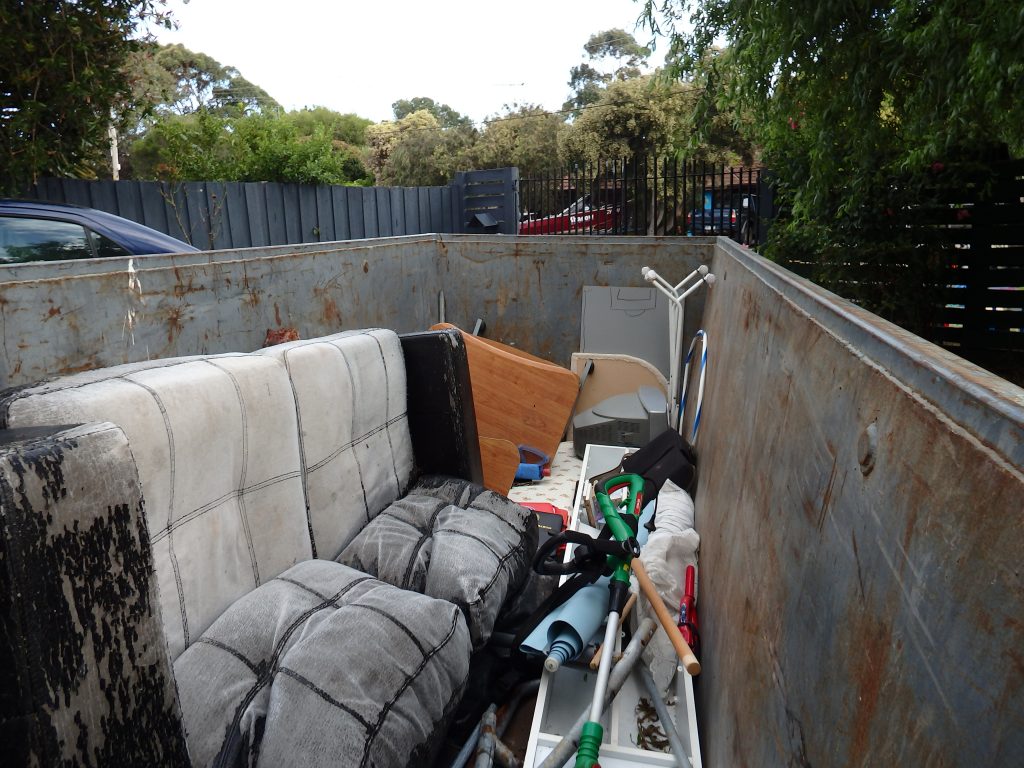 office equipments and furniture in a large skip bin