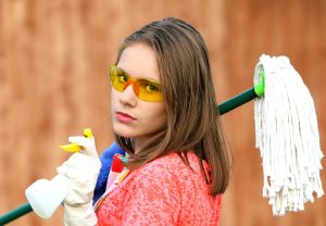 a girl equipped with cleaning items
