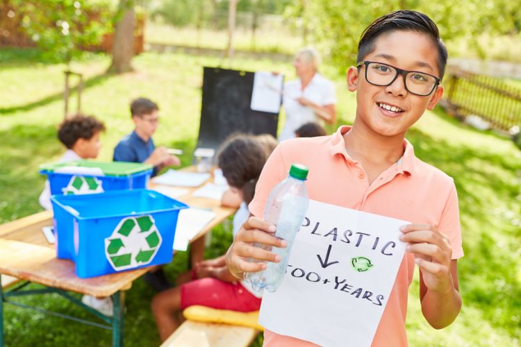 Child recycling plastic bottle