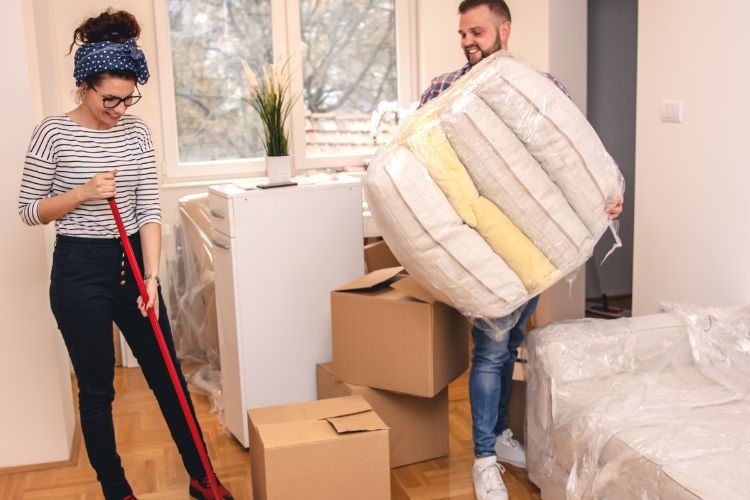 Man and woman cleaning a house