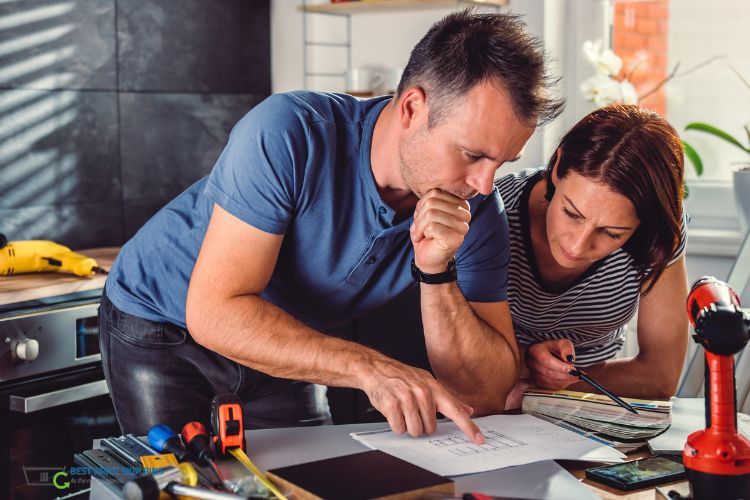 Man and woman pointing at a building plan